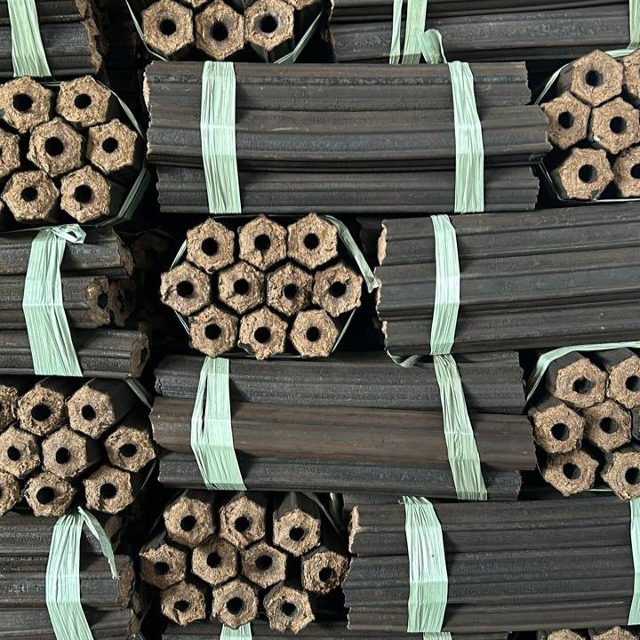 Dried sawdust charcoal briquettes stacked and tied after the drying process.