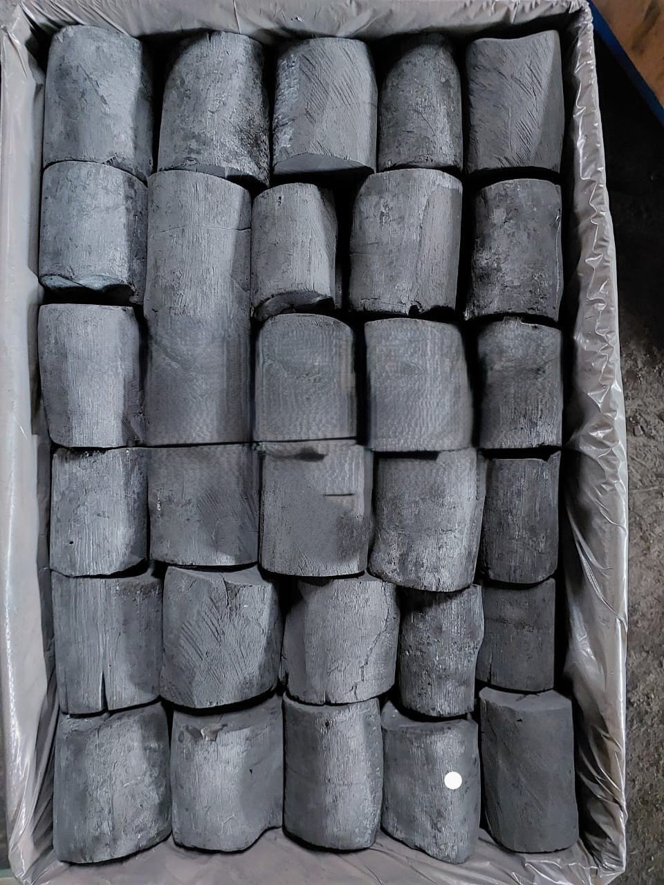 Binchotan hardwood charcoal arranged neatly, showing uniform size and clean carbonization.