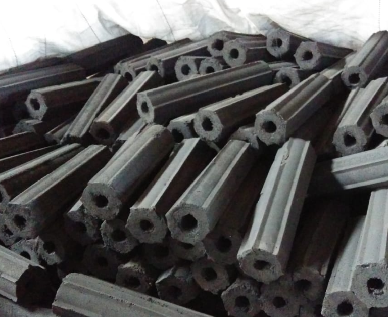 Sawdust charcoal briquettes packed in sacks for bulk handling and export preparation.