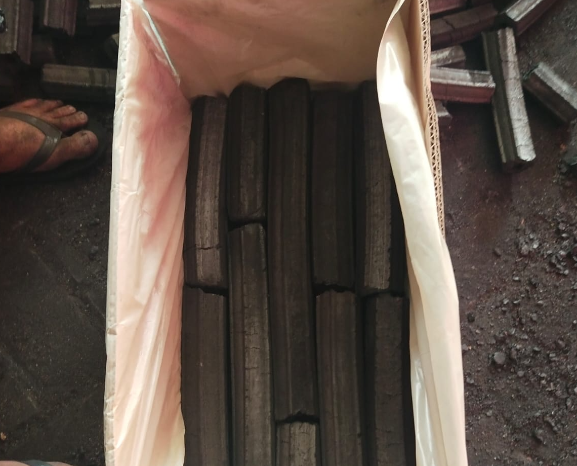 Sawdust charcoal briquettes packed in boxes, prepared for export and international distribution.