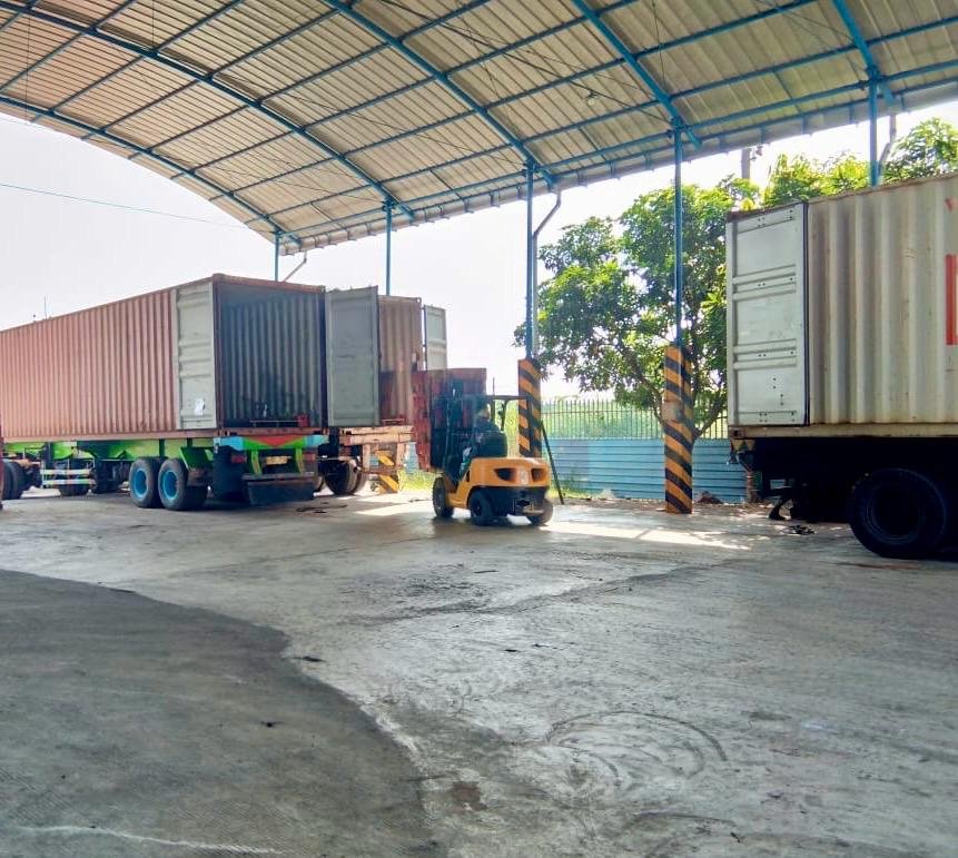Charcoal container stuffing process showing export preparation and loading for international shipment.